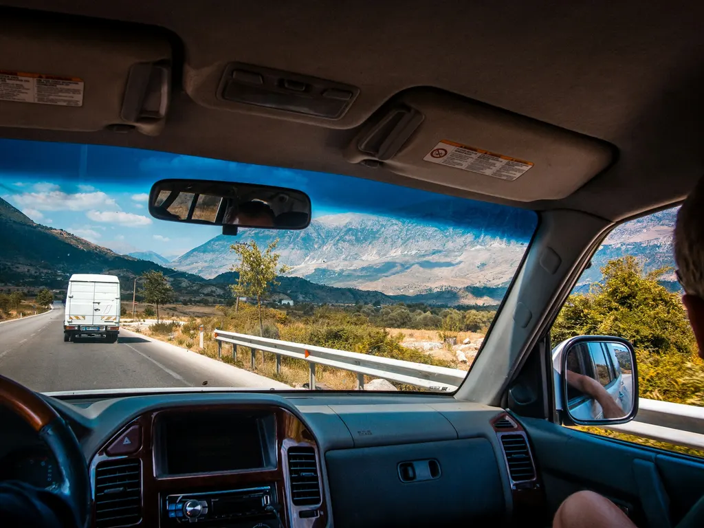 On the road by car, mountains ahead