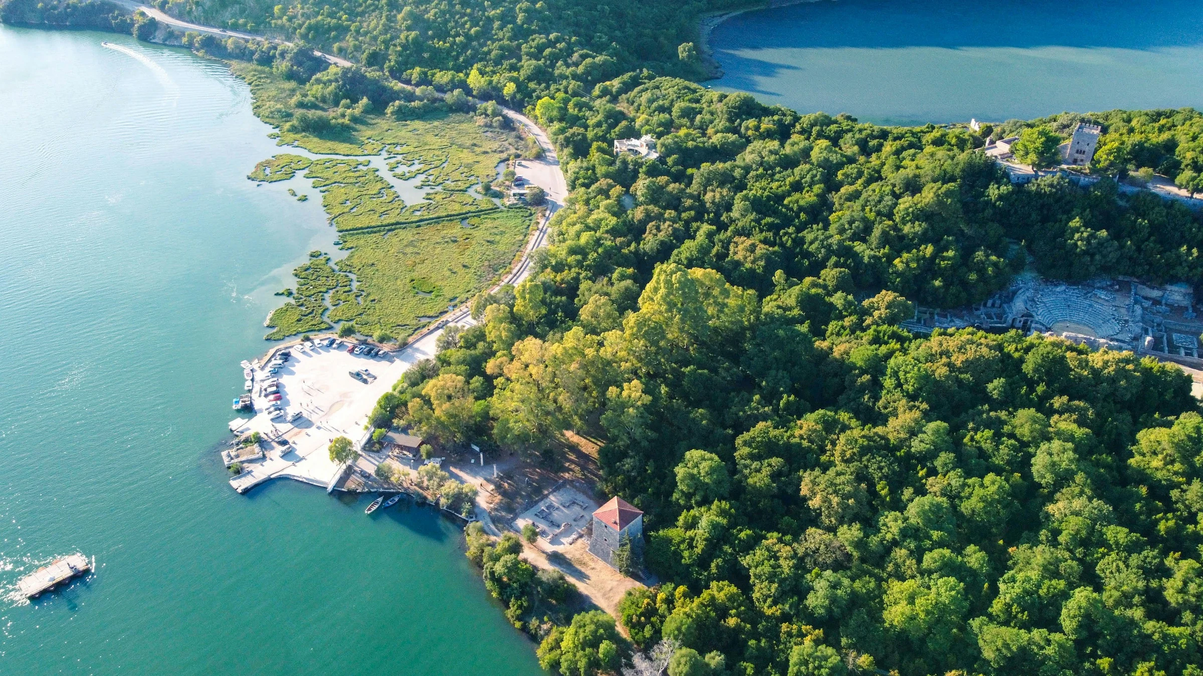 Butrint from above, with the Vivari channel, an old tower and the ancient theatre in the forest