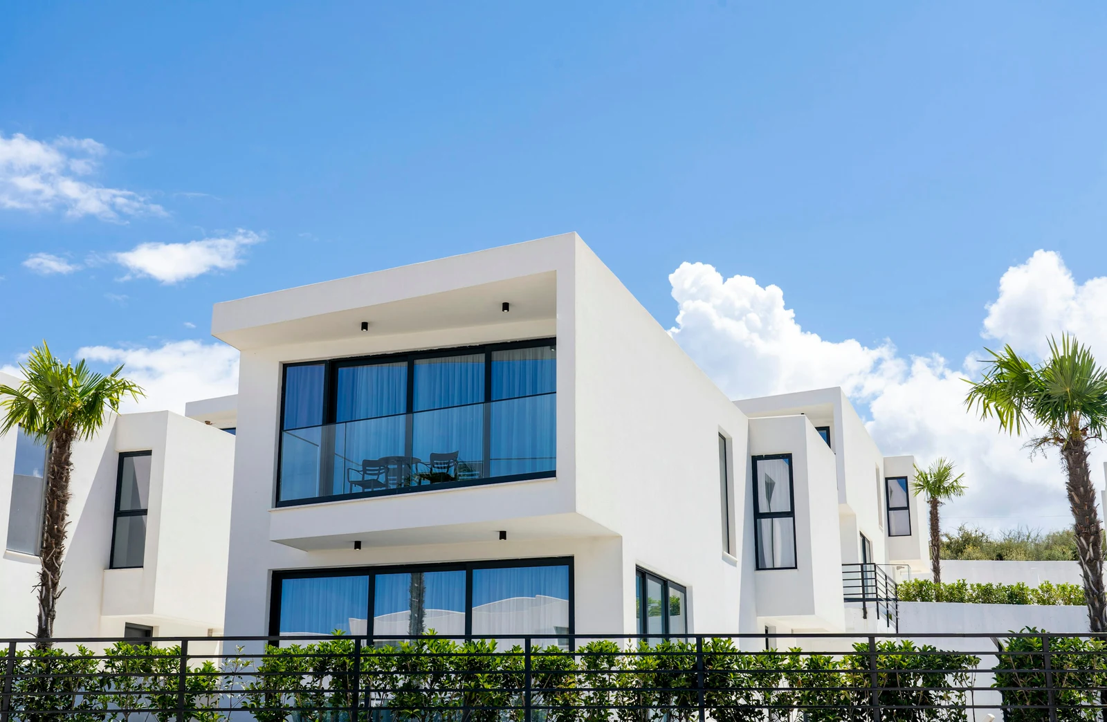 A modern white villa with palm trees