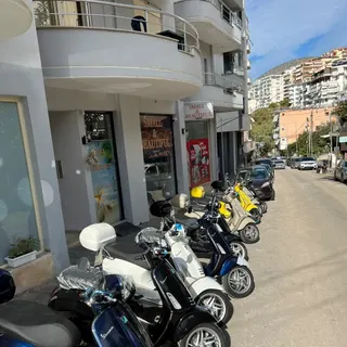 Vespas lined up in front of the Small & Beautiful shop in Sarandë