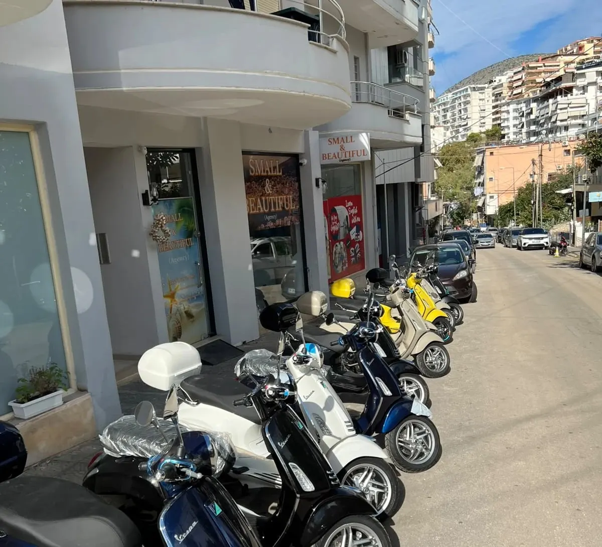 New Vespas lined up in front of the Small & Beautiful shop in Sarandë